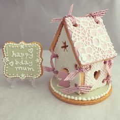 a cake shaped like a house next to a sign