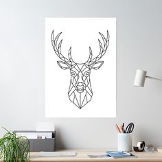 a black and white drawing of a deer's head on a wall above a desk