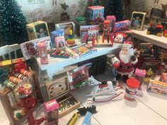 toys and other items are sitting on the floor in front of a christmas display case