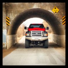 a red truck is driving through a tunnel