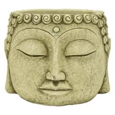 a stone buddha head with eyes closed