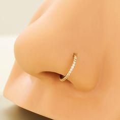 a close up view of a gold ring on a mannequin's head