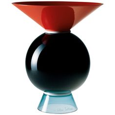 a black and red vase sitting on top of a blue base with a white bottom