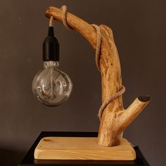 a wooden lamp with a light bulb attached to it