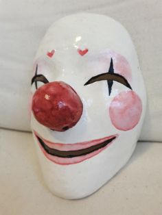 a close up of a clown mask on a couch