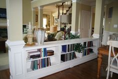 a living room filled with furniture and bookshelves