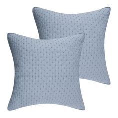 two light blue pillows sitting on top of each other