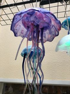 there are many jellyfish hanging from the ceiling