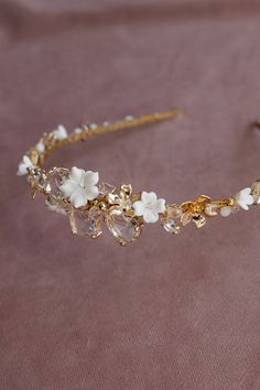 Filled with sparkling crystals and lots of gilded elements, a wedding headband, a bit in the boho style, but also fits into an elegant look, will beautifully decorate any wedding hairstyle. White flowers add charm and subtlety to the whole composition, which will certainly diversify the romantic wedding atmosphere. Length - 41 cm, width - 3.5 cm. Gold Wedding Hair Accessories, Gold Hair Accessories Wedding, Headpiece Wedding Hair, Bridal Halo, Wedding Hair Piece, Wedding Dresses With Flowers, Wedding Headband, Wedding Tiara, Bridal Crown