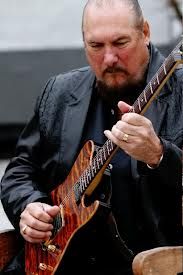 a man playing an electric guitar on stage