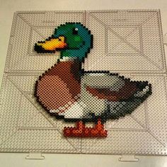 a duck made out of legos sitting on top of a table