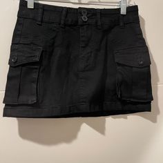 Cute Cargo Skirt. Black. Never Worn (Though Missing Tags). Sits Lower On The Hips (Low To Mid Rise Depending On Torso Length). Black Lined Cargo Skirt, Fitted Black Cargo Skirt With Pockets, High Waist Black Cotton Mini Skirt, Casual Black Cargo Skirt For Summer, Casual Black Cargo Skirt For Spring, Black Cotton Mini Skort, Black Cotton Mini Cargo Skirt, Black High Waist Cotton Cargo Skirt, High Waist Black Cargo Skirt