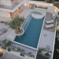 an aerial view of a pool surrounded by landscaping