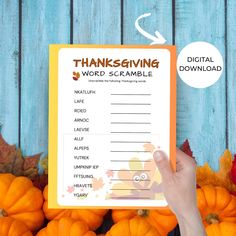 a person holding up a thanksgiving word scramble book in front of pumpkins and leaves