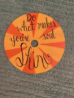 an orange and yellow disc with the words do what makes you soul alive on it