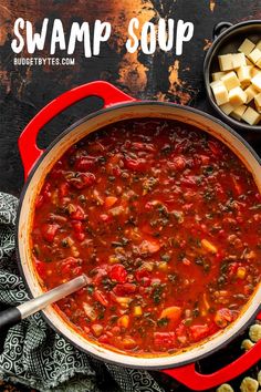 a red pot filled with soup next to other food