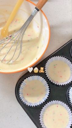 cupcake batter being whisked into muffin tins