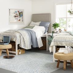 a bedroom with white walls and blue patterned bedding