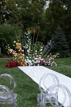 an outdoor ceremony setup with chairs and flowers