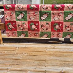 a wooden deck with a quilt on it