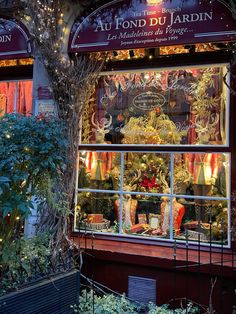 a store front with christmas decorations in the window