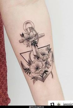 an anchor with flowers on the side of the arm is shown in black and white