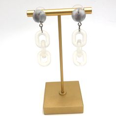 Moonglow button studs meet frosted lucite chain in these retro meets modern statement earrings. Each earring measures just under 2.25" or 58mm in length & are super light weight. Earrings are made with mostly vintage lucite parts that were made in the US in the 1960's - early 80's. We hand-set them with surgical steel earring posts and they have sturdy surgical steel/acrylic backings on them as well. Button Studs, Surgical Steel Earrings, Moon Glow, Earring Posts, Vintage Lucite, Sustainable Brand, Light Weight Earrings, Post Earrings, Geometric Shapes