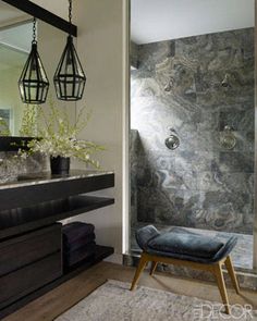 a bathroom with a large mirror, sink and shower stall in it's corner