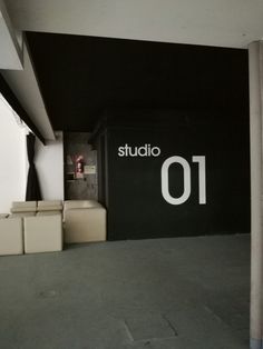 there is a room with black walls and white letters on the wall that say studio 101