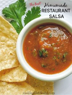 homemade restaurant salsa with tortilla chips and cilantro on the side in a white bowl