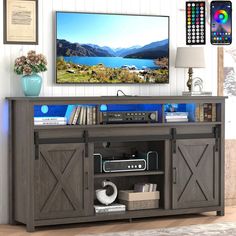 a flat screen tv sitting on top of a wooden entertainment center