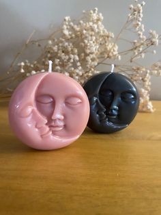 two candles that have faces on them