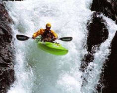 a man is kayaking down a waterfall in the water