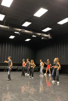 a group of young people standing on top of a dance floor