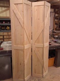 two wooden doors are open in a workshop