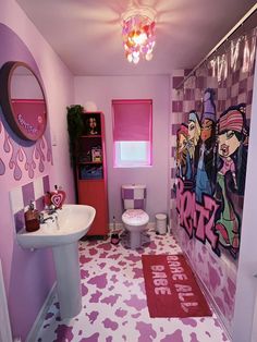 a bathroom decorated in pink, purple and white