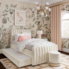 a white bed sitting next to a window in a room with floral wallpaper on the walls