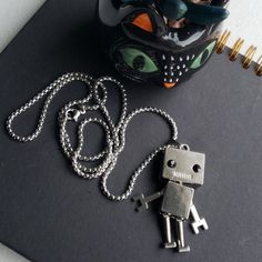 Movable Punk Robot Pendant Necklace. Lobster Clasp Closure. Stainless Steel. Add A Cool Edgy Touch To Your Outfit. (1) Necklace & Pendant. Punk Style Stainless Steel Necklace With Adjustable Chain, Edgy Adjustable Stainless Steel Necklace, Edgy Adjustable Nickel-free Necklace, Punk Stainless Steel Necklace With Adjustable Chain, Robot Necklace, Mens Accessories Jewelry, Silver Man, Necklace Pendant, Black Silver