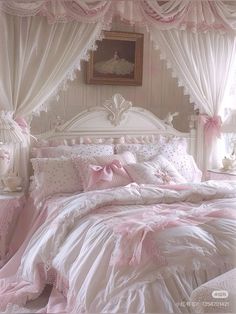 a white bed with pink comforter and pillows