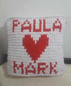 a red and white pillow with the words fall asleep on it's side, sitting on a couch