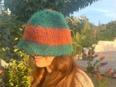 The Fluffy winter beanie handmade is here to keep you warm and stylish. Carefully knitted for a snug fit, this beanie consists of hedge green and orange stripes, creating quite the statement in style. Super-soft yarn with fantastic texture will make this beanie perfect for any chilly days to stay comfortable and warm. Whether you're looking for or need that special accessory or a last-minute handmade gift, this fuzzy winter hat is a statement piece you need for the season. The beanie will suit b Fall Beanie, Fall Beanies, Fluffy Hat, Handmade Beanies, Textured Yarn, Unique Color Combinations, Hat Handmade, Cozy Feeling, Winter Beanie