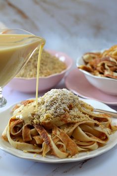 a white plate topped with pasta covered in sauce