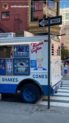 an ice cream truck is parked on the side of the street