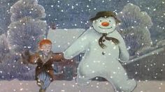 two children are playing in the snow with a snowman