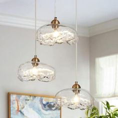 three lights hanging from a ceiling in a living room