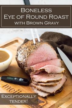 the boneless eye of round roast with brown gravy on a cutting board