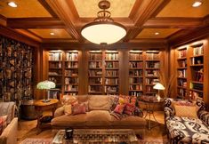 a living room filled with lots of furniture and bookshelves covered in wooden shelves