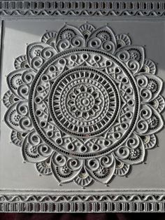 an intricately designed wall hanging on the side of a building