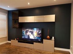 a flat screen tv sitting on top of a entertainment center