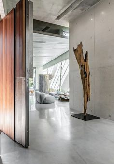 a large wooden sculpture sitting in the middle of a living room next to a doorway